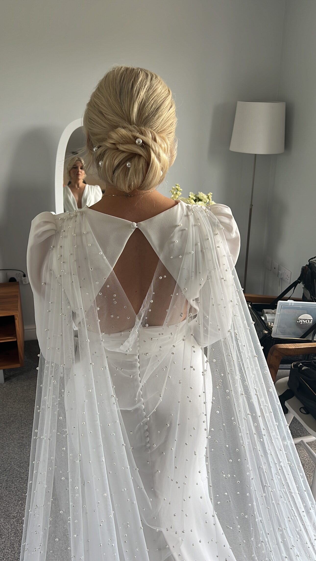 Bride with elegant texture low bun and pearl hair accessories at Hazel Gap Barn Nottingham